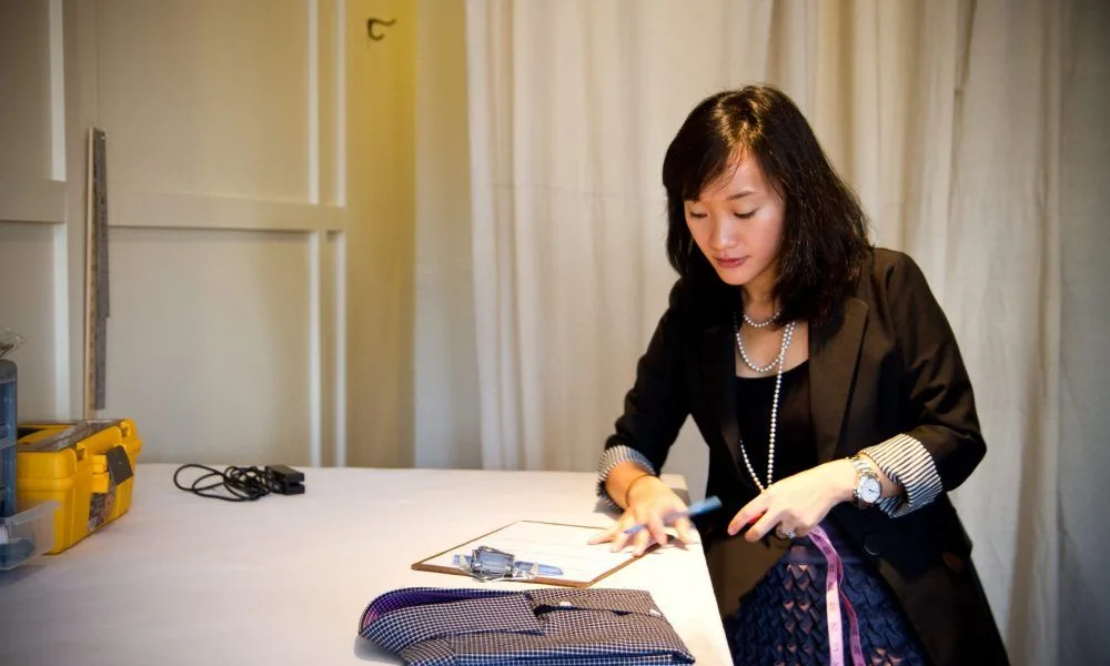 Samantha Shih working with tailoring materials at 9Tailors