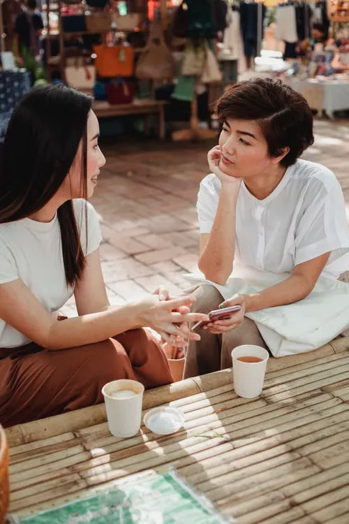 Two people having a candid conversation over coffee