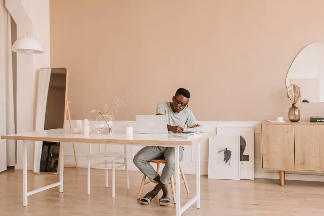 Independent professional working through a business idea at a table in a warm, modern studio
