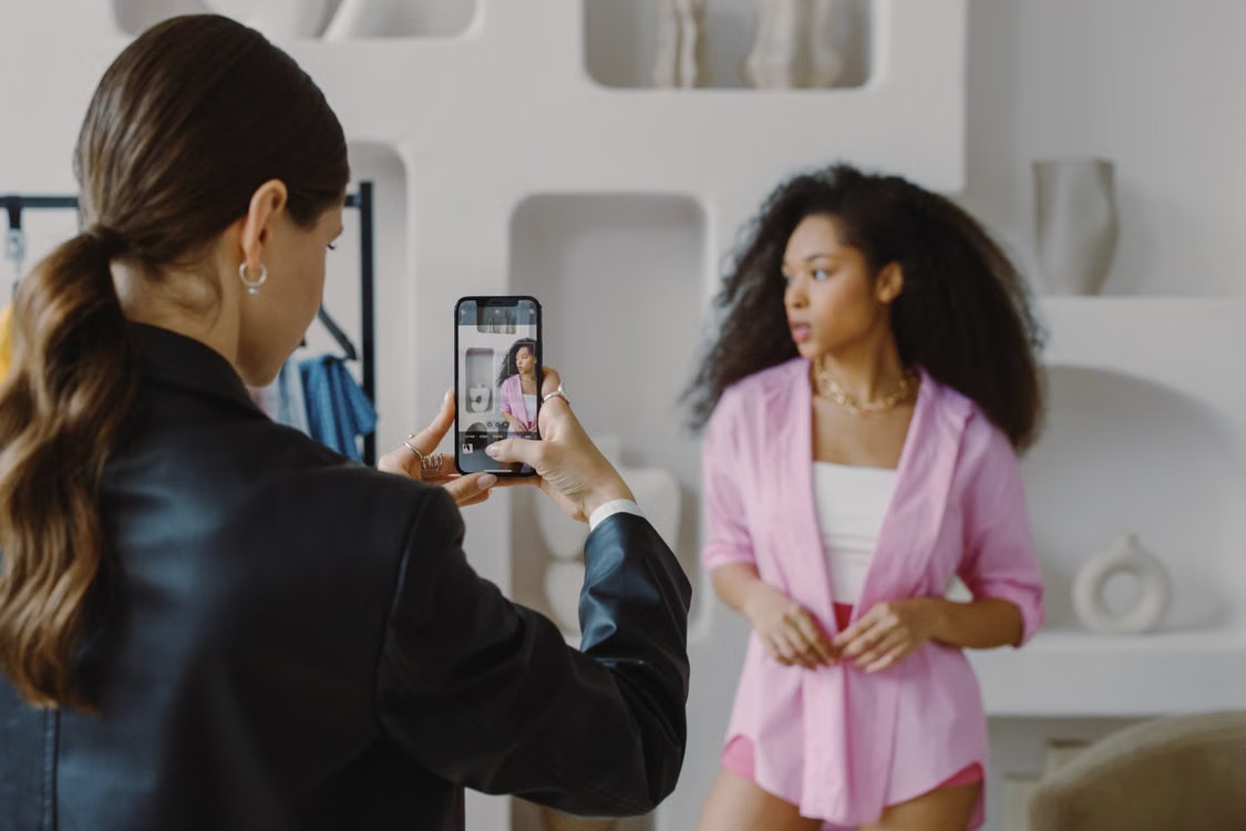 A fashion content producer photographing a model in a studio